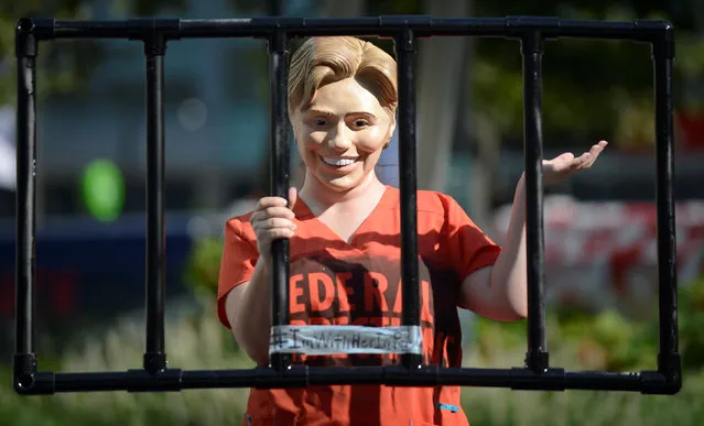 A supporter of Senator Bernie Sanders poses in a costume portraying an imprisoned Hillary Clinton near the Democratic National Convention in Philadelphia, Pennsylvania, U.S., July 26, 2016. (Photo by Bryan Woolston/Reuters)