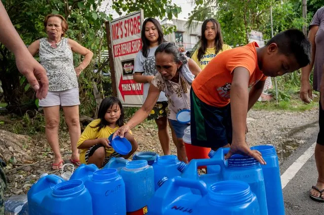 Residents prepare to fill their water containers, in the aftermath of an earthquake in Bangued, Abra province, Philippines, July 29, 2022. (Photo by Lisa Marie David/Reuters)