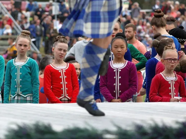 Highland dancers watch other competitors at the annual Braemar Highland Gathering in Braemar, Scotland, Britain on September 3, 2022. (Photo by Russell Cheyne/Reuters)