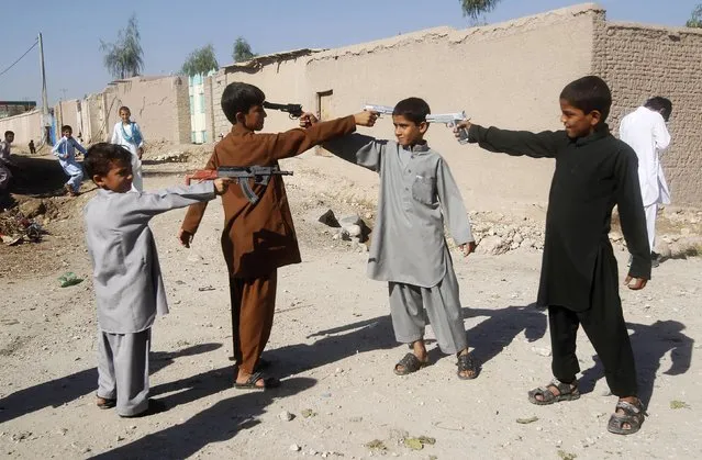 Afghan boys play with toy guns on the first day of Eid al-Adha in Jalalabad October 15, 2013. (Photo by Reuters/Parwiz)