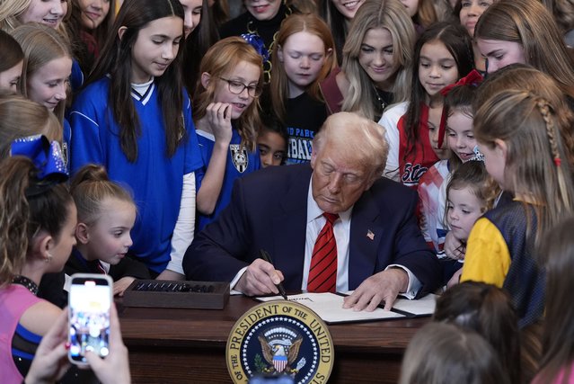President Donald Trump signs an executive order barring transgender female athletes from competing in women's or girls' sporting events, in the East Room of the White House, Wednesday, February 5, 2025, in Washington. (Photo by Alex Brandon/AP Photo)