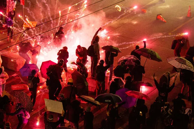 Demonstrators clash with police near the Seattle Police Departments East Precinct on June 7, 2020 in Seattle, Washington. Earlier in the evening, a suspect drove into the crowd of protesters and shot one person, which happened after a day of peaceful protests across the city. Later, police and protestors clashed violently. (Photo by David Ryder/Getty Images)