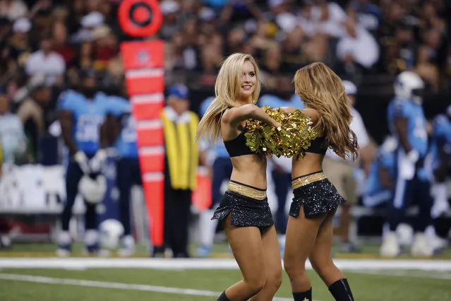 New Orleans Saints cheerleaders perform during an NFL preseason football game against the Tennessee Titans in New Orleans, Friday, August 15, 2014. (Photo by Bill Haber/AP Photo)