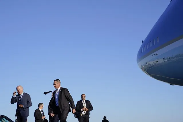President Joe Biden, bottom left, and members of the U.S. Secret Service walk to motorcade vehicles after stepping off Air Force One, Thursday, October 20, 2022, at Philadelphia International Airport in Philadelphia. Biden is visiting Philadelphia to attend a reception for Pennsylvania Lt. Gov. John Fetterman, a Democratic candidate for U.S. Senate. (Photo by Patrick Semansky/AP Photo)