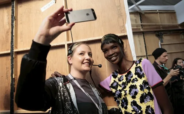 A member of the technical crew takes a selfie with a model following the presentation of the Sibling Spring/Summer 2016 collection during London Fashion Week in London, Britain September 19, 2015. (Photo by Suzanne Plunkett/Reuters)