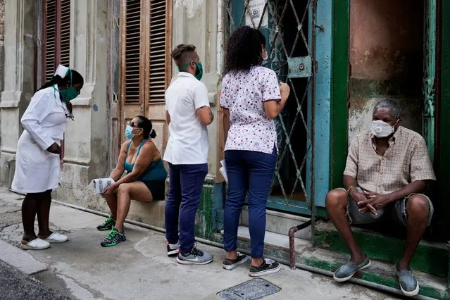 Medical students check door to door for people with symptoms amid concerns about the spread of the coronavirus disease (COVID-19), in downtown Havana, Cuba, May 11, 2020. (Photo by Alexandre Meneghini/Reuters)