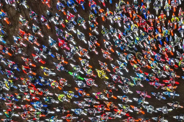 This aerial view taken with a drone shows riders as they compete during the 39th edition of the enduro motorcycle race Gotland Grand National (GGN) at Tofta shooting range, near Visby, on the island of Gotland, Sweden, on October 28, 2022. (Photo by Jonathan Nackstrand/AFP Photo)
