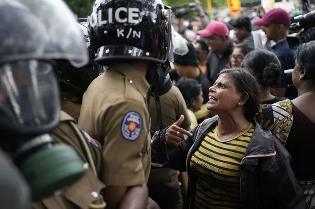 An anti government protester argues with police officers as police blocked their protest march in Colombo, Sri Lanka, Wednesday, November 2, 2022. The protestors were demanding the release of two detained  protest leaders and to end the government’s crackdown on protests against an unprecedented economic crisis that has engulfed the island nation for months. (Photo by Eranga Jayawardena/AP Photo)