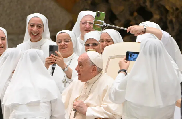Pope Francis poses for a photo with nuns during the weekly general Papal audience in Paolo VI Hall at the Vatican, 17 August 2022. (Photo by Maurizio Brambatti/EPA/EFE)