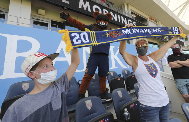 William Taylor and his mother Lucy Taylor hold their banner up with mascot Theo as the Real Monarchs play San Diego Loyal SC in Sandy on Saturday, July 11, 2020. (Photo by Jeffrey D. Allred/Deseret News)
