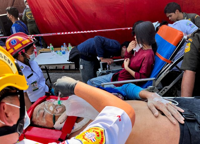 Injured people receive medical attention near the site of a collapsed building in Bangkok, Thailand, on March 28, 2025. (Photo by Ann Wang/Reuters)