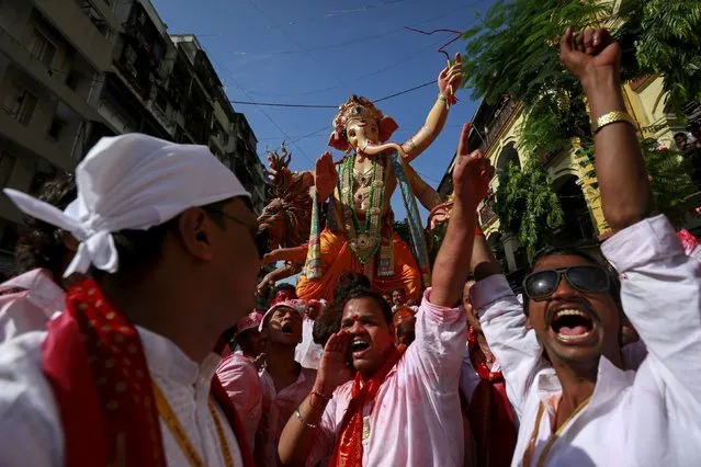 Devotees dance as they pull an idol of Hindu god Ganesh, the deity of prosperity, through a street on the last day of the ten-day-long Ganesh Chaturthi festival in Mumbai, India, September 27, 2015. (Photo by Danish Siddiqui/Reuters)