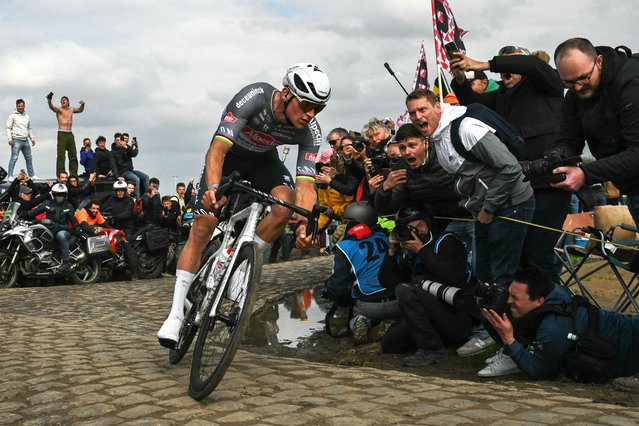 Alpecin-Deceuninck's Dutch rider Mathieu van der Poel cycles in a breakaway leading the race at the Carrefour de l'Arbre, a cobblestone road, during the 122nd edition of the Paris-Roubaix one-day classic cycling race, 259,2 km between Compiegne and Roubaix, northern France on April 13, 2025. (Photo by Jeff Pachoud/AFP Photo)