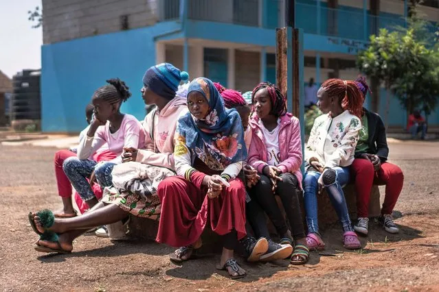 Girls wait to receive distributed sanitary pads at Kibera primary school in the Kibera slum, in Nairobi on July 23, 2020. Kirta Touch The Needy, a local NGO based in Kibera, distributes 20,000 sanitary pads across Kibera slums as girls cannot get sanitary pads at schools, usually provided for free by the government, since all schools are currently closed until next January due to the COVID-19. (Photo by Fredrik Lerneryd/AFP Photo)