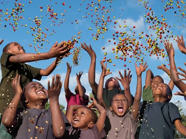 “Future in Our Hands”. Children in Father Peter’s School in Tanzania who symbolise the Earth Defenders of the future, throwing colourful coffee seeds into the air demonstrates that the future really does lie in our own hands. (Photo by Steve McCurry/2015 Lavazza Calendar)