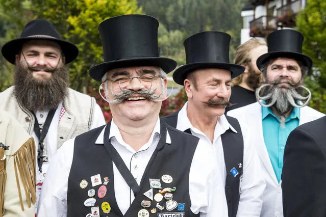 Contestants of the World Beard And Mustache Championships pose for a picture during the opening ceremony of the Championships 2015 on October 3, 2015 in Leogang, Austria. Over 300 contestants in teams from across the globe have come to compete in sixteen different categories in three groups: mustache, partial beard and full beard. The event takes place every few years at different locations worldwide. (Photo by Jan Hetfleisch/Getty Images)