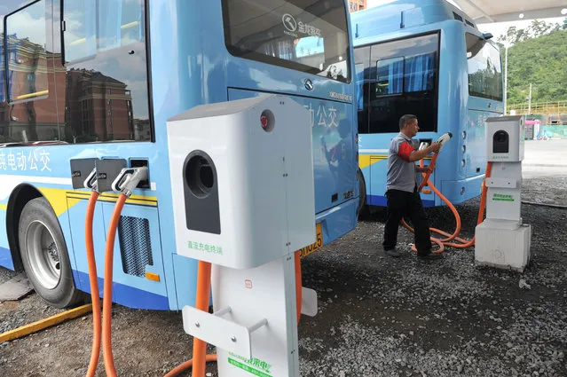 In this Friday, July 15, 2016, photo, a driver charges an electric bus made by King Long United Automotive Industry at a terminal in Lin'an city in eastern China's Zhejiang Province. China's electric vehicle industry, a flagship for Beijing's technology ambitions, has been rocked by scandal after five companies were caught collecting millions of dollars in subsidies for buses they never made. (Photo by Chinatopix via AP Photo)