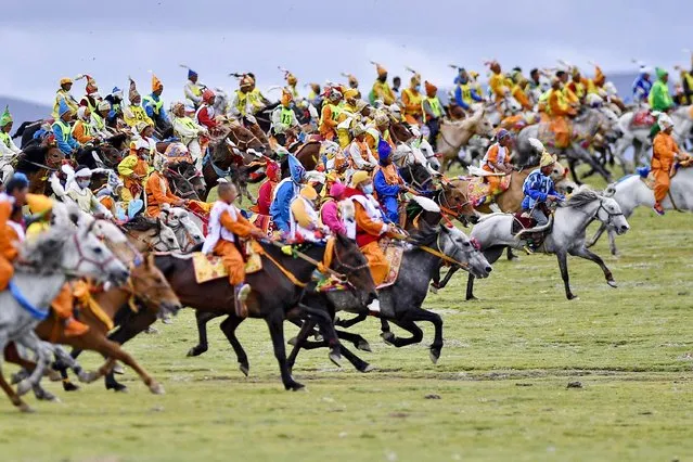 Young riders compete during a traditional horse race at the Nagqu Horse Racing Festival 2020 in Nagqu, southwest China's Tibet Autonomous Region, August 14, 2020. The five-day Nagqu Horse Racing Festival 2020 closed on Friday. (Photo by Zhang Rufeng/Xinhua News Agency)