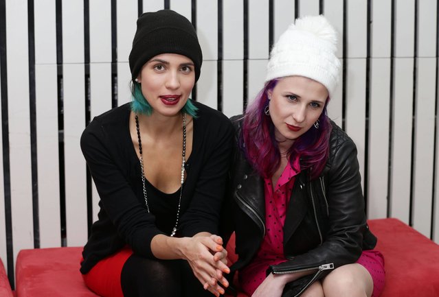 Nadezhda Tolokonnikova (left) and Maria Alekhina of the Russian feminist protest art collective p*ssy Riot during a photocall, at a reception at Amnesty International Human Rights Action Centre, London, on November 14, 2014, where they will address Amnesty activists who campaigned for their release after being jailed for two years for an anti-government protest in Moscow in 2012. (Photo by Yui Mok/PA Wire)