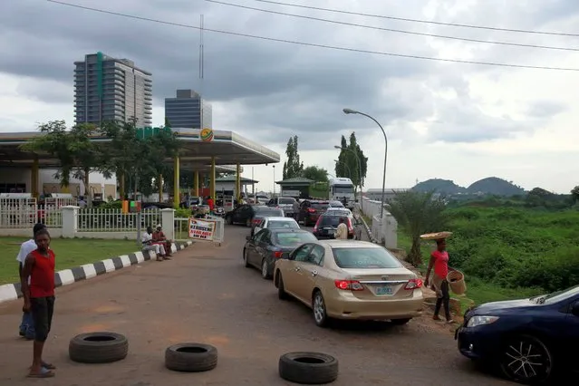 Vehicles queue for the pump after a new petrol price is introduced at the NNPC retail outlet in Abuja, Nigeria on September 3, 2020. (Photo by Afolabi Sotunde/Reuters)