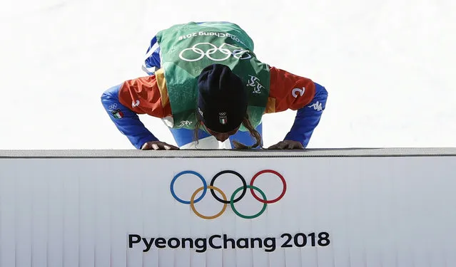 Italy' s Michela Moioli kisses the podium during the victory ceremony after the women' s snowboard cross big final at the Phoenix Park during the Pyeongchang 2018 Winter Olympic Games on February 16, 2018 in Pyeongchang. (Photo by Issei Kato/Reuters)