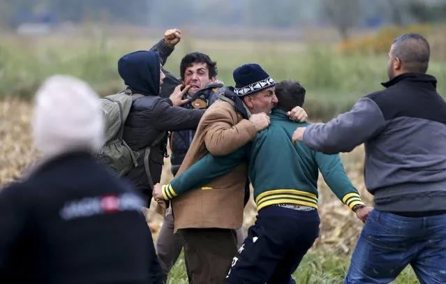 Migrants fight with each other after crossing the border from Croatia in Rigonce, Slovenia, October 22, 2015. Slovenia has asked the European Union for police to help regulate the inflow of migrants from Croatia, Interior Minister Vesna Gyorkos Znidar told TV Slovenia. Over the past 24 hours, more than 10,000 migrants, many fleeing violence in Syria, have arrived in Slovenia, the smallest country on the Balkan migration route, on their way to Austria. (Photo by Srdjan Zivulovic/Reuters)