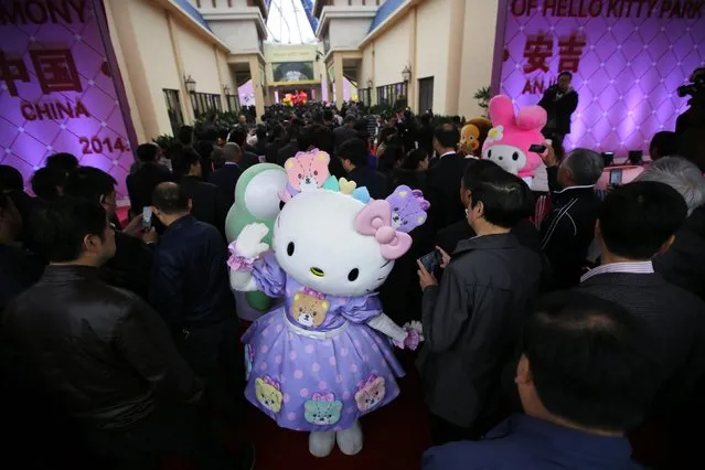 Guests attend an inauguration ceremony of a Hello Kitty amusement park in Anji, Zhejiang province November 28, 2014. (Photo by Carlos Barria/Reuters)