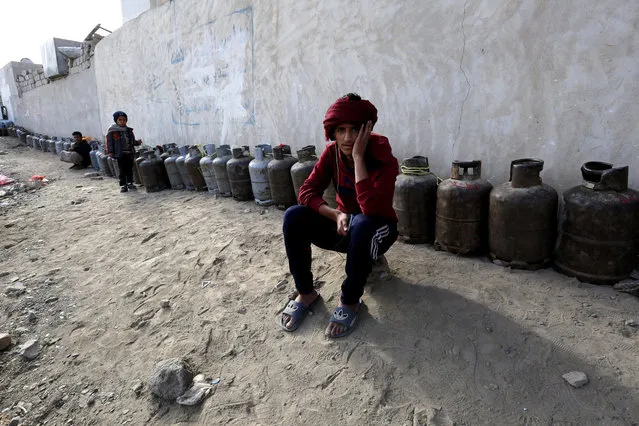 Yemenis wait next to empty cooking gas cylinders for gas supplies at a gas station amid increasing gas shortages in Sana'a, Yemen, 05 March 2018. According to reports, Yemen continues to experience severe cooking gas shortages since the Saudi-led coalition started a military campaign against the Houthi rebels and their allies in the impoverished Arab state three years. (Photo by Yahya Arhab/EPA/EFE)
