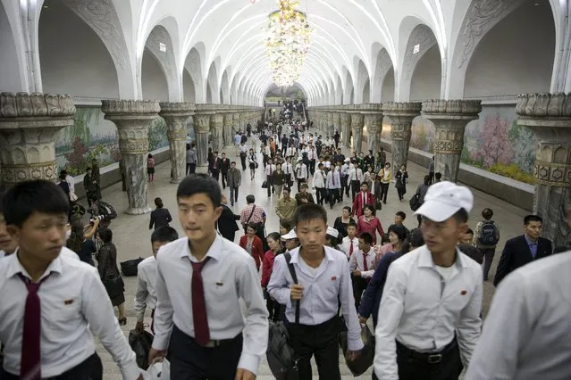 Commuters make their way through a subway station visited by foreign reporters during a government organised tour in Pyongyang, North Korea October 9, 2015. (Photo by Damir Sagolj/Reuters)