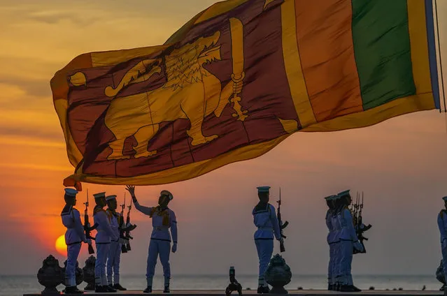 Sri Lanka Navy personnel lowering the Galle Face Promenade national flag at sunset on January 1, 2023 in Colombo, Sri Lanka. The Sri Lanka Navy takes on the daily hoisting and lowering duty of the national flag at Galle Face Promenade. (Photo by Thilina Kaluthotage/NurPhoto/Rex Features/Shutterstock)