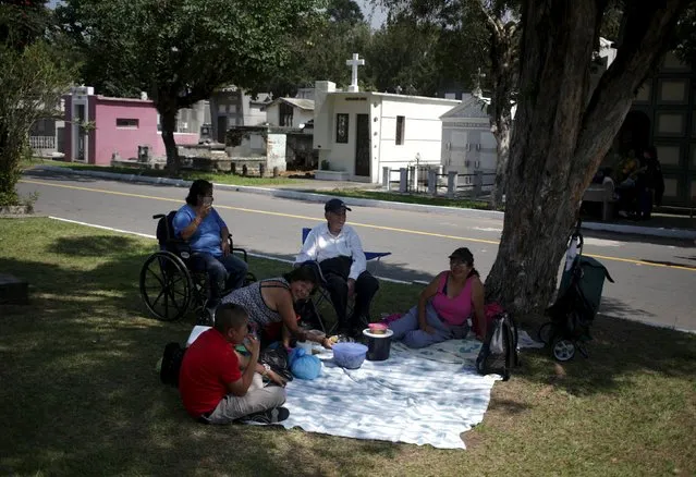A family enjoys a picnic at the General Cemetery in Guatemala City, October 31, 2015. (Photo by Jorge Dan Lopez/Reuters)