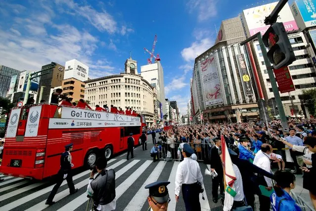 Japanese Rio 2016 Olympics and Paralympics athletes wave to fans during a parade in Tokyo, Japan, October 7, 2016. (Photo by Shizuo Kambayashi/Reuters)