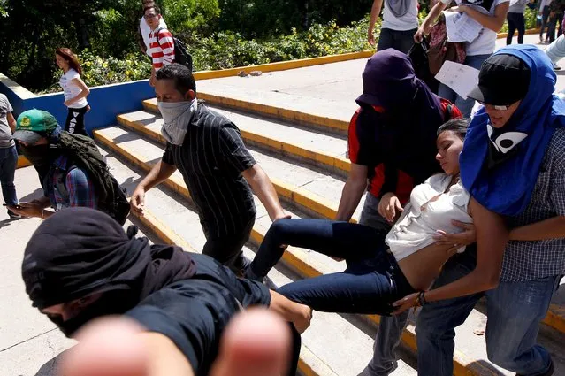Students carry a protestor that fainted during a protest to demand the resignation of Honduran President Juan Orlando Hernandez in Tegucigalpa, Honduras, November 4, 2015. (Photo by Jorge Cabrera/Reuters)