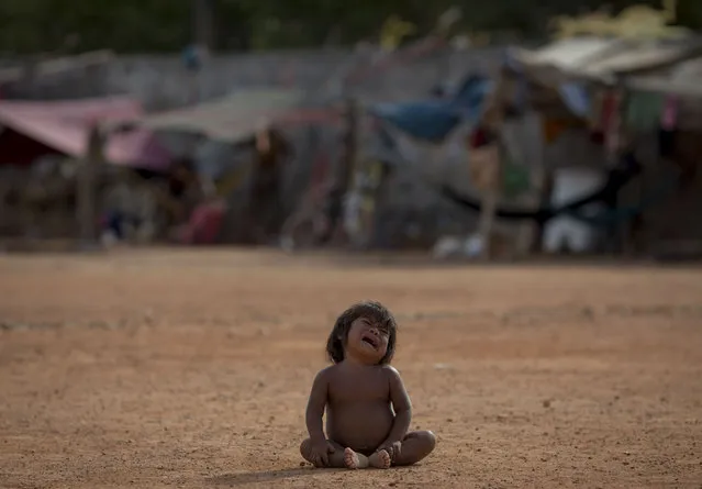 A Venezuelan indigenous refugee child cries at a shelter in the city of Boa Vista, Roraima, Brazil, on February 24, 2018. According with local authorities, around one thousand refugees are crossing the Brazilian border each day from Venezuela. With the constant influx of Venezuelan immigrants most are living in shelters and the streets of Boa Vista and Paracaima cities, looking for work, medical care and food. Most are legalizing their status to stay and live in Brazil. (Photo by Mauro Pimentel/AFP Photo)