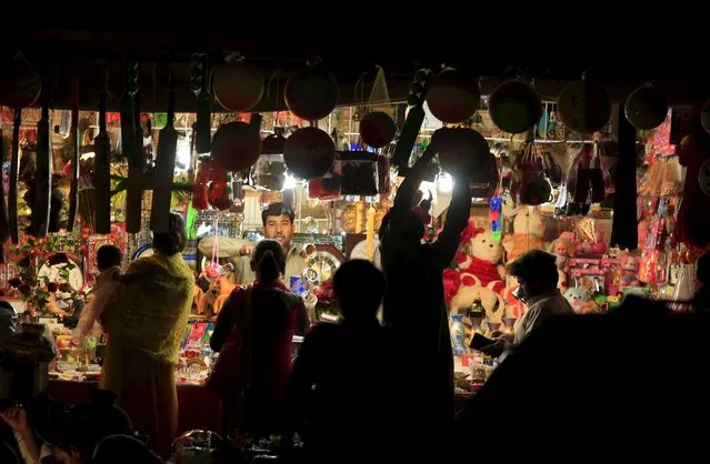 Women buy gifts from a toy shop on the outskirts of Islamabad, Pakistan, October 7, 2015. (Photo by Faisal Mahmood/Reuters)