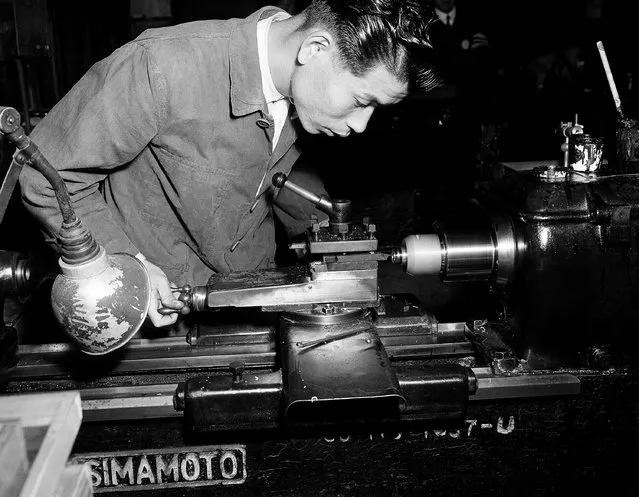 Working at a lathe, an employee at the Nikon factory machines a lens barrel mount in Tokyo, December 28, 1951. Cameras will be one of Japan's major export items in the post-peace era. (Photo by Bob Schutz/AP Photo)