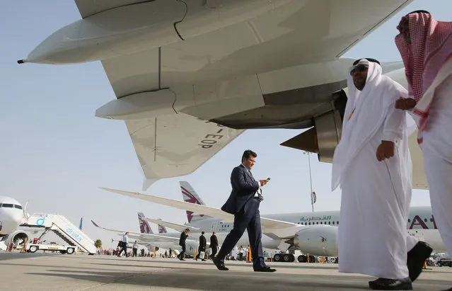 People walk around the planes during the opening of the Dubai Airshow in Dubai, United Arab Emirates, Sunday, November 8, 2015. (Photo by Kamran Jebreili/AP Photo)