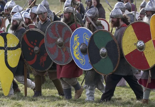 Re-enactors participate in a demonstration before a re-enactment of the the Battle of Hastings on the 950th anniversary of the battle, in Battle, Britain October 15, 2016. (Photo by Neil Hall/Reuters)