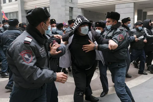 Police officers try to stop opposition demonstrators as they rally to pressure Armenian Prime Minister Nikol Pashinyan to resign over a peace deal with neighboring Azerbaijan in Yerevan, Armenia, Tuesday, December 22, 2020. Opposition supporters in Armenia on Tuesday ramped up the pressure on the prime minister to resign over his handling of the Nagorno-Karabakh conflict with Azerbaijan. (Photo by Hrant Khachatryan/PAN Photo via AP Photo)