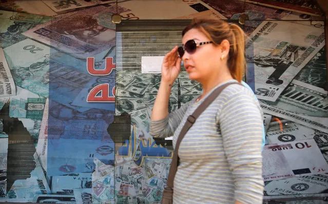 A woman walks past a money exchange bureau showing images of the U.S dollar and other foreign currencies in Cairo, Egypt, October 12, 2016. (Photo by Amr Abdallah Dalsh/Reuters)