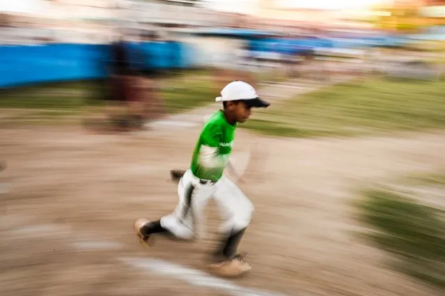 A boy runs during a baseball training class in Havana, on March 6, 2023. The 2023 World Baseball Classic begins March 7, 2023 when the Netherlands and Cuba kick off the fifth edition of the international event. For the first time, major and minor leaguers who defected from Cuba are being allowed to play for the team in international competition. (Photo by Yamil Lage/AFP Phoot)