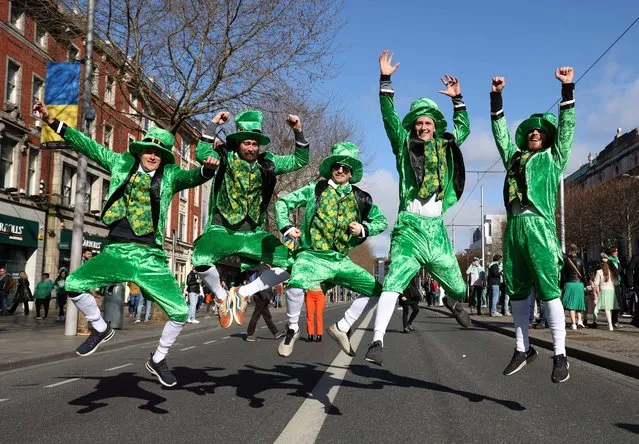 Revellers from Denmark dressed in green pose photo during the the annual St Patrick's Day parade in Dublin on March 17, 2022. (Photo by Damien Eagers/AFP Photo)