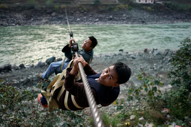 Villagers are seen crossing the river with a zipline in Lazimi village in Nujiang Lisu Autonomous Prefecture in Yunnan province, China, March 24, 2018. (Photo by Aly Song/Reuters)