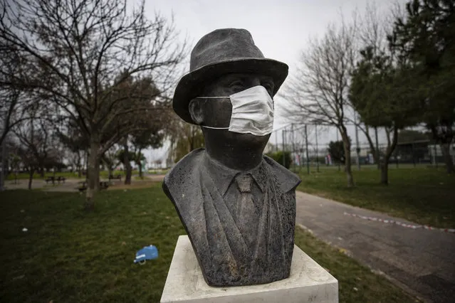 A sculpture of Munir Nurettin Selcuk wears maks as Kalamis and its surroundings remain empty after a general curfew imposed weekend-long from Friday 9 p.m. to Monday 5 a.m. local time within new measures against a second wave of the (coronavirus) COVID-19 pandemic, in Istanbul, Turkey on January 9, 2021. (Photo by Sebnem Coskun/Anadolu Agency via Getty Images)