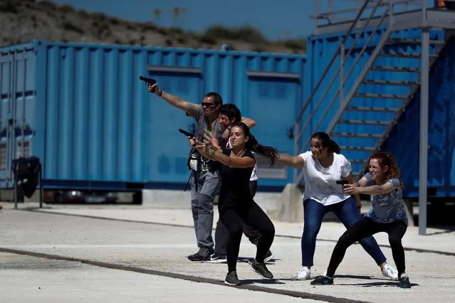 Several people take part in an anti-terrorist and emergency drill in Rivas-Vaciamadrid, outside Madrid, Spain, 13 June 2018. More than 300 people participated in the drill. (Photo by Emilio Naranjo/EPA/EFE)