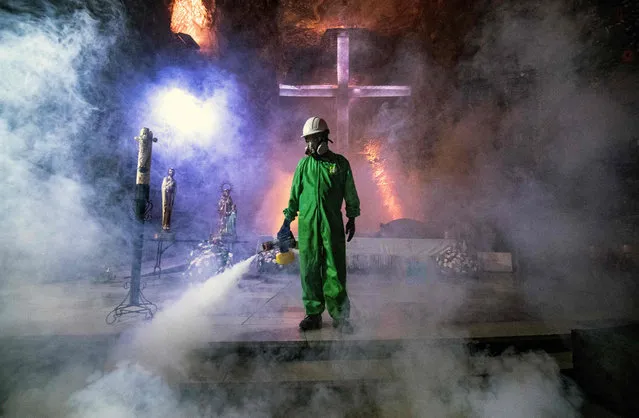 A worker disinfects the Salt Cathedral of Zipaquira, an underground church built into a salt mine, in Zipaquira, 45 km north of Bogota, on August 30, 2020, during the COVID-19 coronavirus pandemic. The Salt Cathedral, one of Colombia's main touristic attractions, is waiting for an authorization from the Health Ministry for its reopening. (Photo by Juan Barreto/AFP Photo)