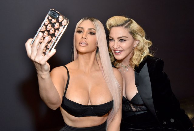 American media personality and socialite Kim Kardashian and American singer-songwriter Madonna backstage at MDNA SKIN hosts Madonna and Kim Kardashian West for a beauty conversation at YouTube Space LA on March 6, 2018 in Los Angeles, California. (Photo by Kevin Mazur/Getty Images for Madonna's MDNA SKIN)