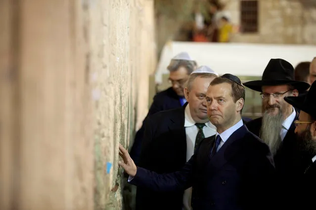 Russia's Prime Minister Dmitry Medvedev touches the stones during a visit to the Western Wall in Jerusalem November 10, 2016. (Photo by Dan Balilty/Reuters)