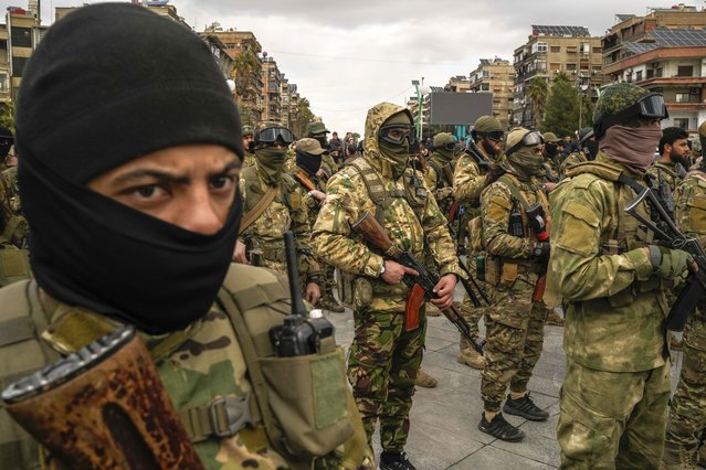 Members of the new armed forces, former rebels who overthrew Bashar Assad's government and now serve in the new Syrian government, stand in formation as they prepare for a military parade in downtown Damascus, Syria, Friday, December 27, 2024. (Photo by Leo Correa/AP Photo)
