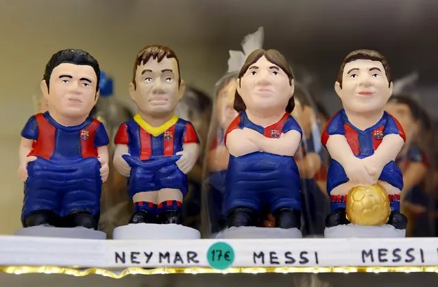 Clay "caganers" representing FC Barcelona's players (L-R) Luis Suarez, Neymar and Lionel Messi are seen on display at the Santa Llucia Christmas market in central Barcelona, Spain, December 16, 2015. (Photo by Albert Gea/Reuters)